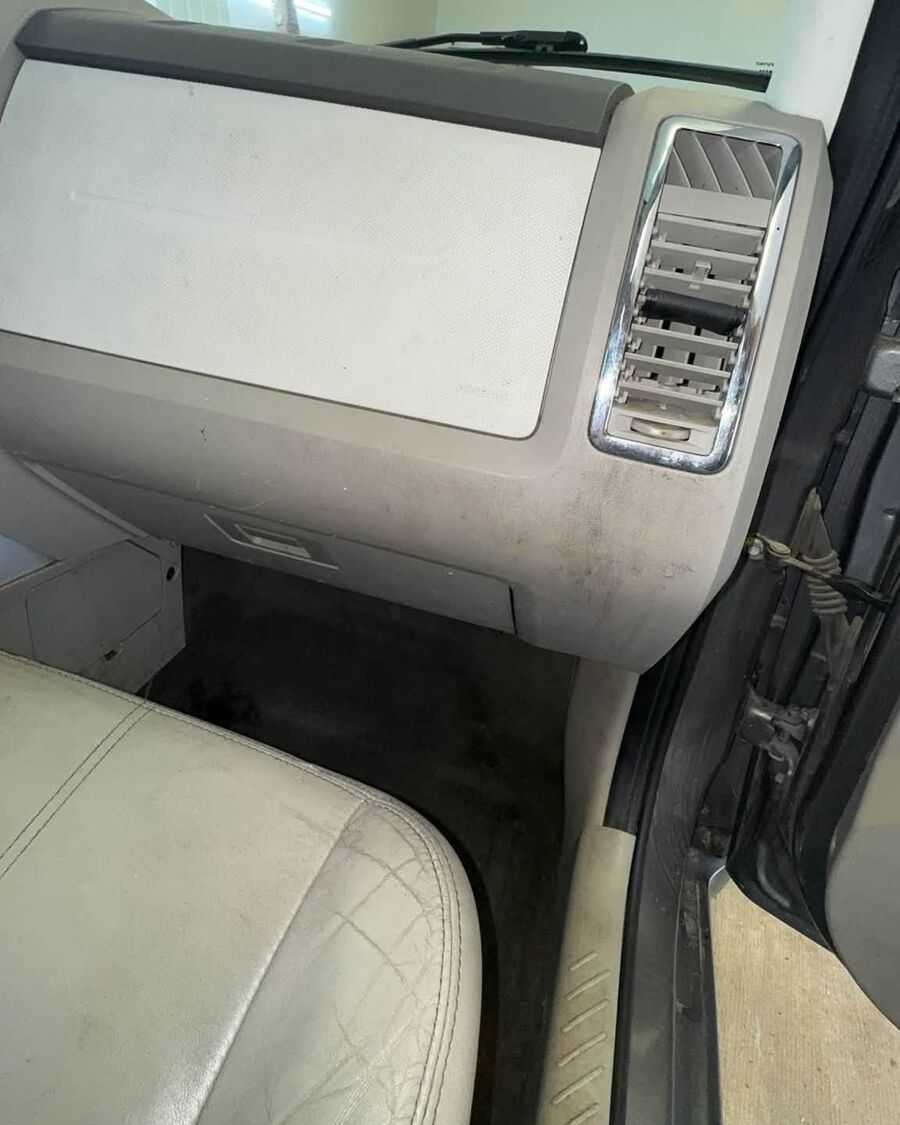 Passenger dash and floor before, dust on the dash and dirt on the carpet